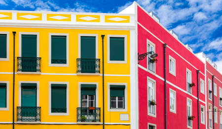 Street perspective view with colorful traditional houses. Lisbon, Portugal. Colorful buildings of Lisbon historic center, Portugal. Street with colorful houses in Lisbon, Portugal.の写真素材