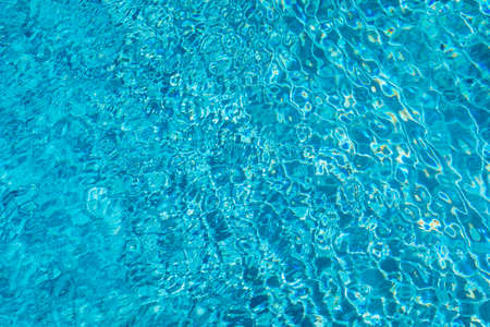Blue ripped water in swimming pool. Surface of blue swimming pool, background of water in swimming...