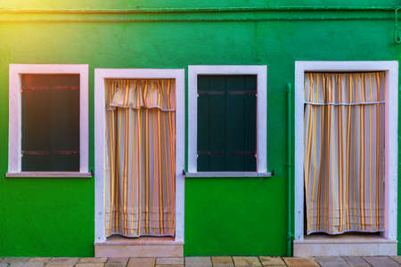 Lovely house facade and colorful walls in Burano, Venice. Burano island canal, colorful houses and boats, Venice landmark, Italy. Europeの写真素材