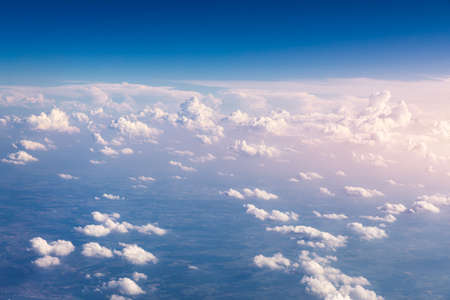 Amazing clouds and the sky as seen through the window of an aircraft. Clouds, sun, sky as seen...