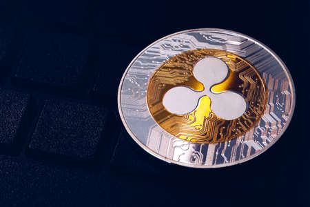 Ripple cryptocurrency (crypto currency). Silver Ripple coin with gold Ripple symbol. Ripple (XRP) cryptocurrency.の写真素材
