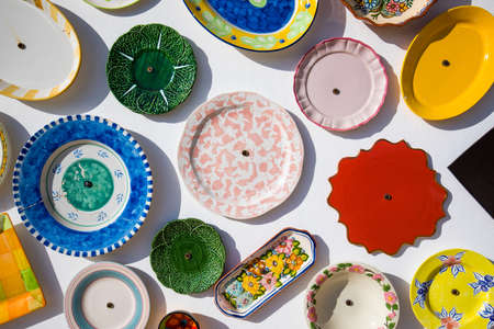 Collection of colorful Portuguese ceramic pottery, local craft products from Portugal. Ceramic plates display in Portugal. Colorful of vintage ceramic plates in Sagres, Portugal.の写真素材