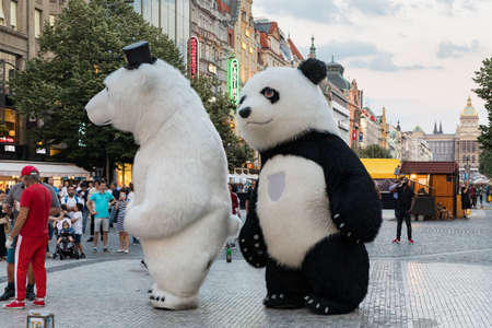 Prague, Czech Republic - May 26, 2018: Men dancing in a Polar bear and Panda bear fancy dress costumes entertains a crowd of people in Wenceslas Square. Prague, Czechia.のeditorial素材