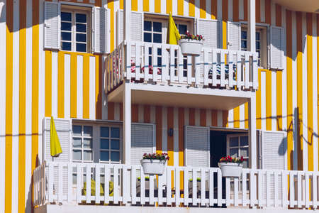 Street with colorful houses in Costa Nova, Aveiro, Portugal. Street with striped houses, Costa Nova, Aveiro, Portugal. Facades of colorful houses in Costa Nova, Aveiro, Portugal.の写真素材