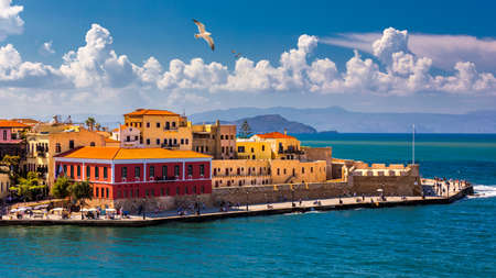 Old port of Chania with flying seagulls. Landmarks of Crete island. Bay of Chania at sunny summer...