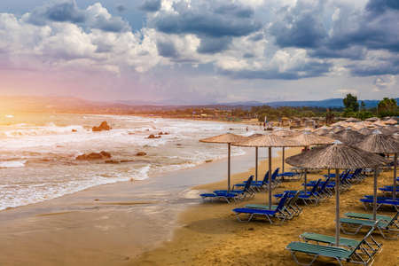 View of sunbeds awaiting tourists at the Greek island resort of Georgioupolis on Crete north coast. Georgioupoli is a resort village and former municipality in the Chania regional unit, Crete, Greece.の写真素材