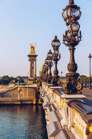 Pont Alexandre III bridge over river Seine in the sunny summer morning. Bridge decorated with ornate...
