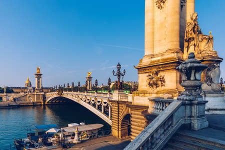 Pont Alexandre III bridge over river Seine in the sunny summer morning. Bridge decorated with ornate Art Nouveau lamps and sculptures. The Alexander III Bridge across Seine river in Paris, France.の写真素材