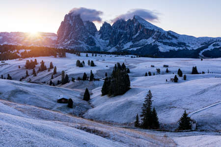 Small wooden farm house, cottage or log cabins on meadow on Alpe di Siusi, Seiser Alm. Alpe di Siusi...