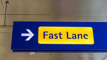 Fast Lane sign in blue and yellow at the airport close up. Fast Lane sign airport first class luxury...