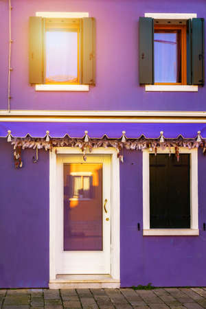Colorful window of a house on the Venetian island of Burano, Venice. Facade of the houses of Burano close-up. Venice, Italy.の写真素材