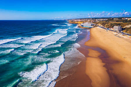 Praia Grande, Portugal. Beautiful sunset in the portuguese beach Praia Grande, in Portugal. Beach of Praia Grande. View of Atlantic beach and big waves. Colares, Sintra, Portugal.の写真素材