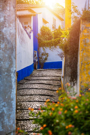 Historic walled town of Obidos, near Lisbon, Portugal. Beautiful streets of Obidos Medieval Town, Portugal. Street view of medieval fortress in Obidos. Portugal.の写真素材