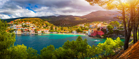 Turquoise colored bay in Mediterranean sea with beautiful colorful houses in Assos village in...