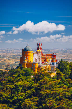Famous historic Pena palace part of cultural site of Sintra against sunset sky in Portugal. Panoramic View Of Pena Palace, Sintra, Portugal. Pena National Palace at sunset, Sintra, Portugal.のeditorial素材