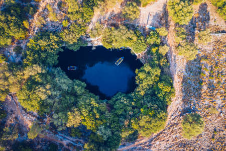 Famous Melissani lake on Kefalonia island, Karavomylos, Greece. On top of Melissani Cave (Melissani Lake) in Karavomylos village in Kefalonia island , Greece. Melissani Cave viewed from above.の写真素材
