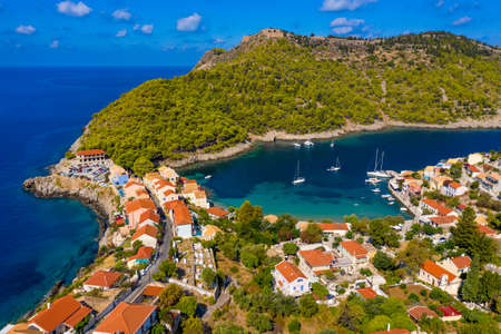 Aerial drone view video of beautiful and picturesque colorful traditional fishing village of Assos...