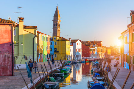 Street with colorful buildings in Burano island, Venice, Italy. Architecture and landmarks of Burano, Venice postcard. Scenic canal and colorful architecture in Burano island near Venice, Italyの写真素材