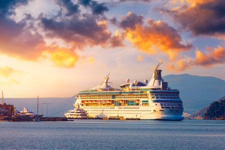 Cruise ship at harbor. Beautiful large white ship at sunset. Colorful landscape with cruiser in marina bay, sea, colorful sky. Luxury cruise ship leaving port at sunset.の写真素材