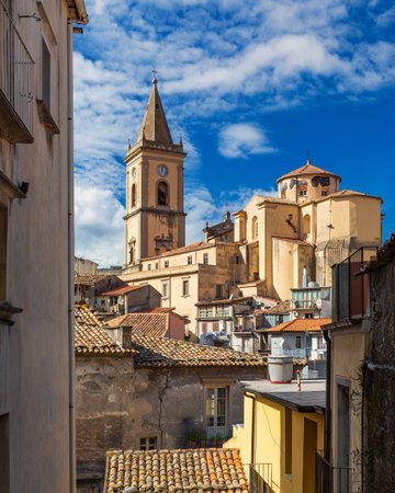 Picturesque street with the Duomo in the background in Novara di Sicilia, Sicily, Italy. Amazing cityscape of Novara di Sicilia town. Mountain village Novara di Sicilia, Sicily, Italy.の写真素材