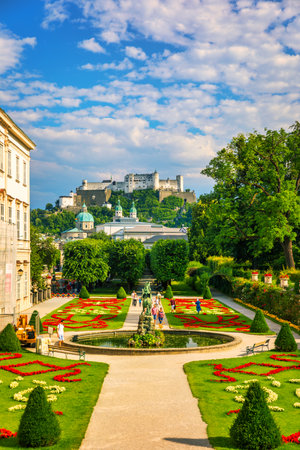 Beautiful view of famous Mirabell Gardens with the old historic Fortress Hohensalzburg in the background in Salzburg, Austria. Famous Mirabell Gardens with historic Fortress in Salzburg, Austria.のeditorial素材