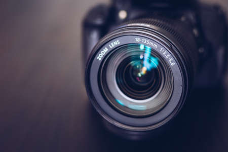 DSLR camera isolated on a black background. Black DSLR Camera isolated. Photo Camera or Video lens close-up on black background DSLR objectiveの写真素材