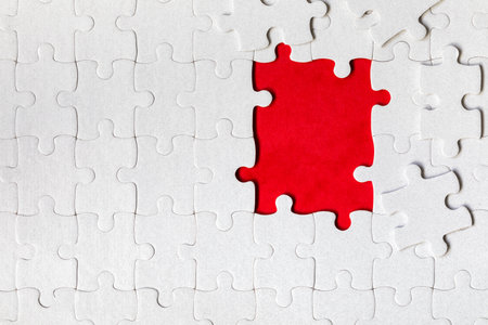 White jigsaw puzzle. White puzzle pieces on color background. Unfinished white jigsaw puzzle pieces on color background.の写真素材