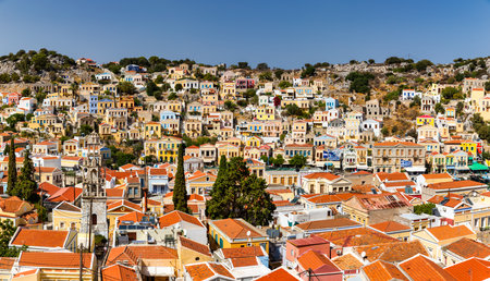 View of the beautiful greek island of Symi (Simi) with colourful houses and small boats. Greece,...