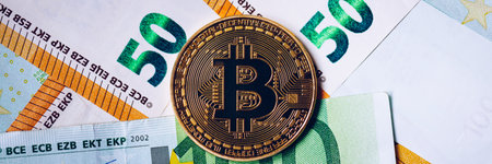 Golden bitcoin over Euro money. Bitcoin cryptocurrency. Crypto currency concept. Bitcoin with euro...