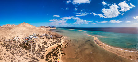 Jandia Peninsula, Risco del Paso, Playas de Sotavento and Laguna de Sotavento, Fuerteventura, Canary Islands, Spain, Atlantic, Europe. Kitesurfing flying in the ocean, Sotavento beach, Fuerteventuraの写真素材
