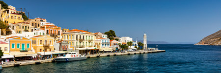 View of the beautiful greek island of Symi (Simi) with colourful houses and small boats. Greece, Symi island, view of the town of Symi (near Rhodes), Dodecanese.のeditorial素材