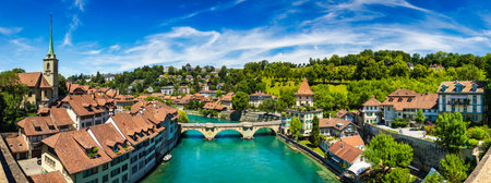 View of the Bern old city center and Nydeggbrucke bridge over river Aare, Bern, Switzerland. Bern old town with the Aare river flowing around the town on a sunny day, Bern, Switzerland.のeditorial素材