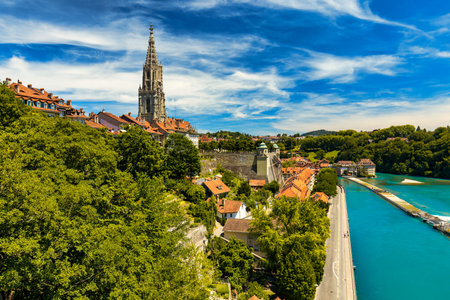 View of the Bern old city center and Nydeggbrucke bridge over river Aare, Bern, Switzerland. Bern...