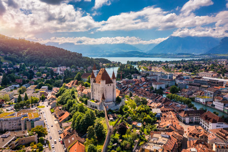 Panorama of Thun city with Alps and Thunersee lake, Switzerland. Historical Thun city and lake Thun with Bernese Highlands swiss Alps mountains in background, Canton Bern, Switzerland.のeditorial素材