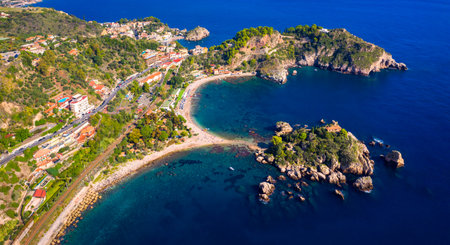 Aerial view of Isola Bella in Taormina, Sicily, Italy. Isola Bella is small island near Taormina, Sicily, Italy. Narrow path connects island to mainland Taormina beach in azure waters of Ionian Sea.の写真素材