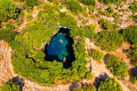 Famous Melissani lake on Kefalonia island, Karavomylos, Greece. On top of Melissani Cave (Melissani Lake) in Karavomylos village in Kefalonia island , Greece. Melissani Cave viewed from above.の写真素材