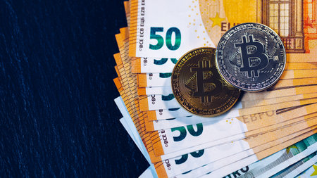 Golden bitcoin over Euro money. Bitcoin cryptocurrency. Crypto currency concept. Bitcoin with euro...