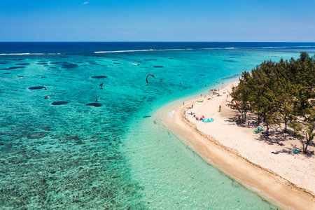 Kitesurfers, windsurfers on the Le Morne beach, famous aquatic sports spot in Mauritius island. Kite surfing in the clear waters of the Indian Ocean in Le Morne beach, Mauritius.の写真素材