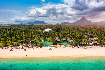 Beach of Flic en Flac with beautiful peaks in the background, Mauritius. Beautiful Mauritius Island with gorgeous beach Flic en Flac, aerial view from drone. Flic en Flac Beach, Mauritius Island.の写真素材