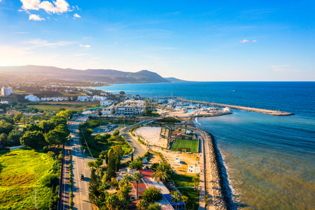 View of Latchi port, Akamas peninsula, Polis Chrysochous, Paphos, Cyprus. The Latsi harbour with boats and yachts, fish restaurant, promenade, beach tourist area and mountains, Latchi, Cyprus.の写真素材