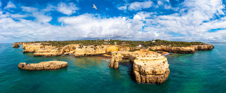 Natural arch above ocean, Arco de Albandeira, Algarve, Portugal. Stone arch at Praia de Albandeira,...