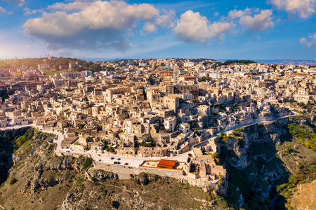 Panoramic view of the ancient town of Matera (Sassi di Matera) in a beautiful autumn day, Basilicata, southern Italy. Stunning view of the village of Matera. Matera is a city on a rocky outcrop.の写真素材