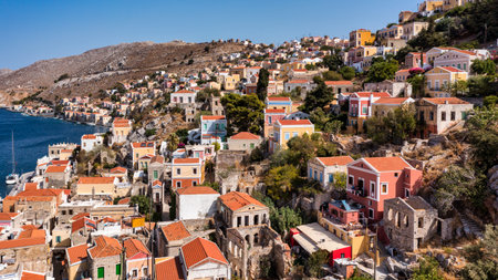 Aerial view of the beautiful greek island of Symi (Simi) with colourful houses and small boats....