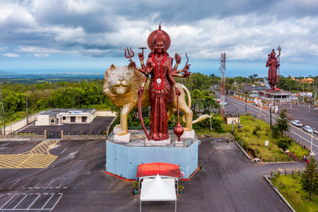 A powerful Statue of the Hindu goddess Durga Maa with a golden lion in sacred Ganga Talao. Shiva statue at Grand Bassin temple, the world's tallest Shiva temple, it is 33 meters tall. Mauritiusの写真素材