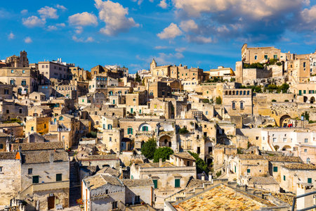 Panoramic view of the ancient town of Matera (Sassi di Matera) in a beautiful autumn day, Basilicata, southern Italy. Stunning view of the village of Matera. Matera is a city on a rocky outcrop.の写真素材