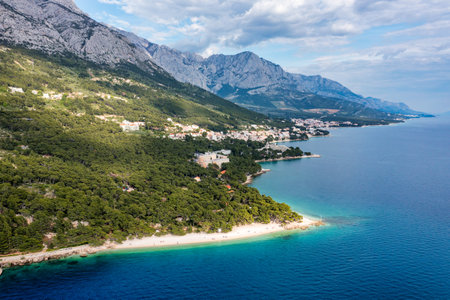 Beautiful aerial view of Punta Rata beach in Brela, Makarska Riviera, Croatia. Aerial view of Punta Rata beach and waterfront on Makarska riviera, Brela, Dalmatia region of Croatia.の写真素材