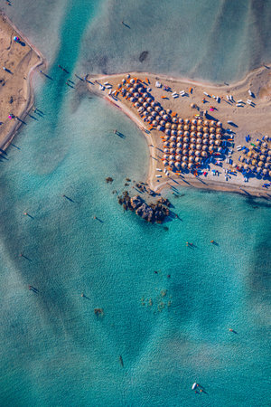 Aerial view of beautiful tropical Elafonissi Beach with pink sand. View of a nice tropical Elafonissi beach from the air. Beautiful sky, sea, resort. Elafonissi beach, Crete, Greece.の写真素材
