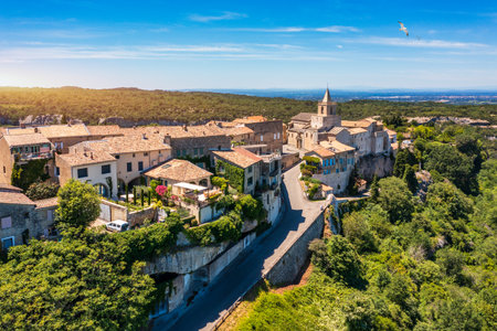 View of Venasque village with old church Notre Dame de Vie to landscape of Luberons, Provence, France. Beautiful Church and houses in the town of Venasque, Provence, France.の写真素材