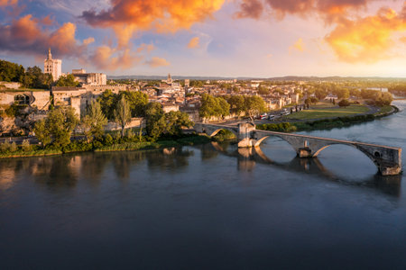 Beautiful view of Avignon with famous bridge Saint-Benezet, medieval architecture along the Rhone River in Avignon, France. The Pont Saint Benezet and the Papal palace in Avignon, South France.の写真素材