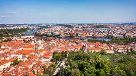 View of Prague featuring vibrant rooftops on a sunny day in summer. Aerial view of Prague, Charles Bridge over Vltava river in Prague, Czechia. Old Town of Prague, Czech Republic.の写真素材